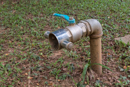 Big old water valve in gardenの写真素材