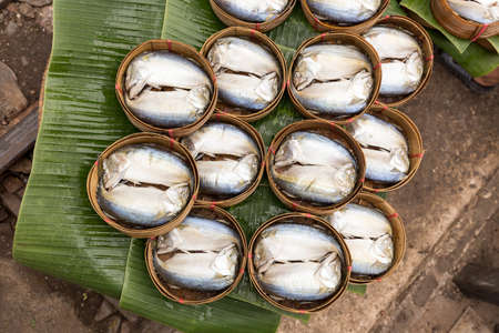 Steamed Mackerel in bamboo basket ready to sell at train market Thailandの写真素材