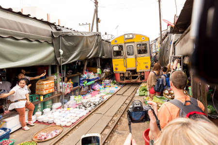 MAEKLONG, THAILAND 2014: The famous railway markets at Maeklong, Thailand.