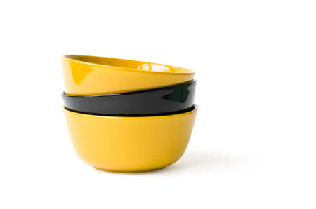 Three yellow and black bowls on the white backgroundの写真素材
