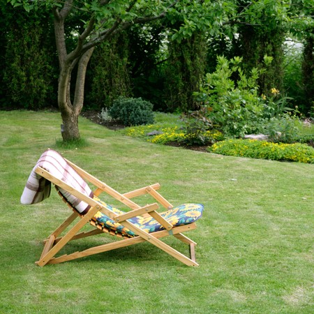 wooden garden chair in beautiful green garden