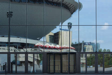 Katowice, Poland - July 10, 2016: The reflection in the glass walls of the Congress Centre in Katowice. The visible part of the show hall "Spodek"のeditorial素材