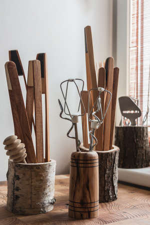 Kitchen gadgets in beautiful wooden mugs.の写真素材