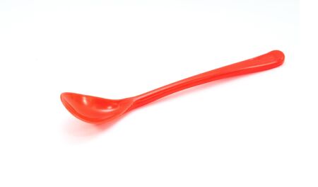 Red plastic spoon isolated on white backgroundの写真素材