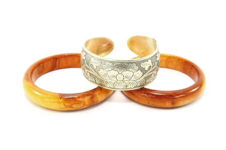 Silver and wooden bracelets isolated on white backgroundの写真素材