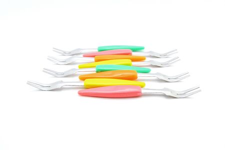 Small forks for fruit on white backgroundの写真素材