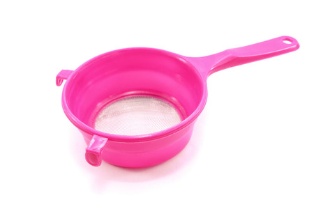 Pink handle colander isolated on white backgroundの写真素材
