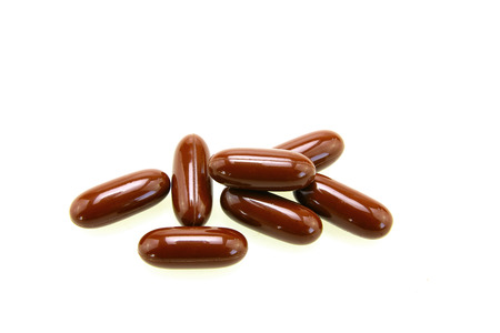 Brown pills isolated on white backgroundの写真素材