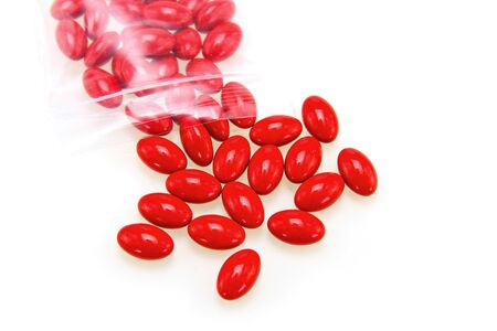Red pills isolated on white backgroundの写真素材