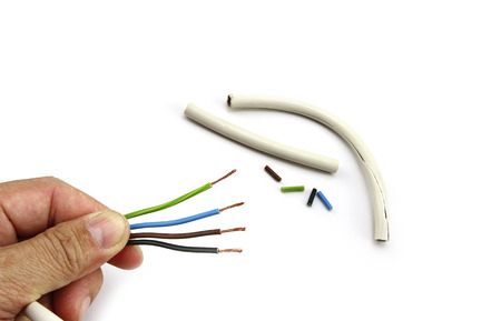 Electric cable in hand on white backgroundの写真素材