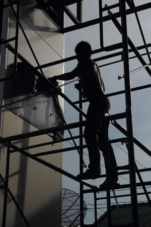 Construction site, silhouettes of workersの写真素材