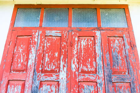 Red wooden window with white wallの写真素材