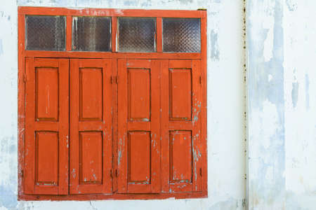 Red wooden window with white wallの写真素材
