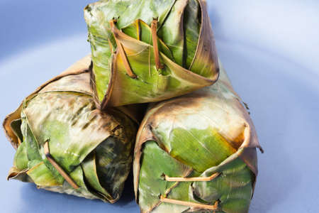 Sticky rice roast , wrapped in banana leaves.の写真素材