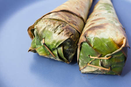 Sticky rice roast , wrapped in banana leaves.の写真素材