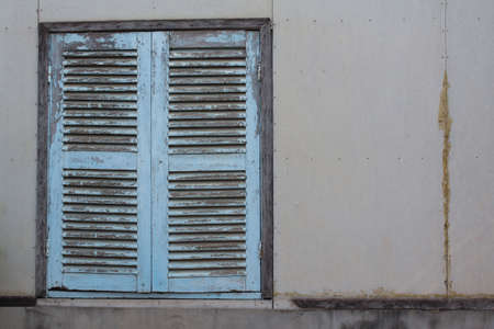 Vintage window on white cement wallの写真素材