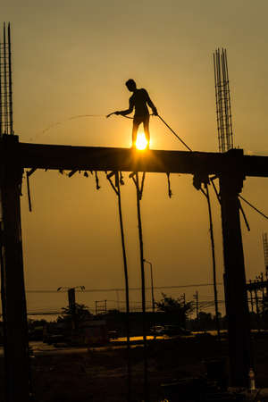silhouette of constructionworker on constructionsiteの写真素材