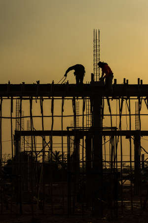 silhouette of constructionworker on constructionsiteの写真素材