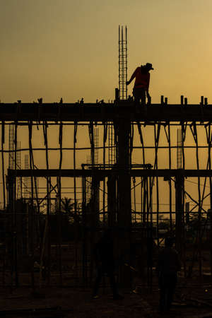 silhouette of constructionworker on constructionsiteの写真素材