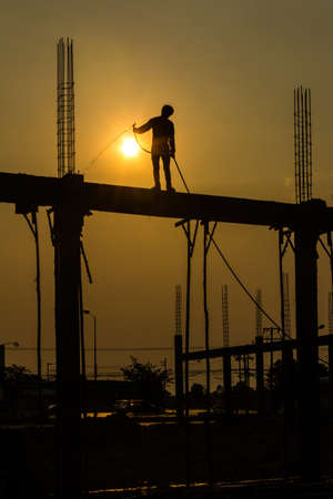 silhouette of constructionworker on constructionsiteの写真素材