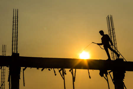 silhouette of constructionworker on constructionsiteの写真素材