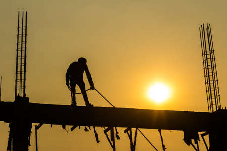 silhouette of constructionworker on constructionsiteの写真素材