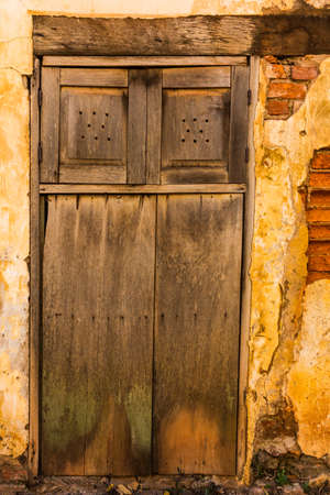 old brick wall with wooden doorの写真素材