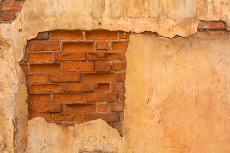old brick wall with cracked stuccoの写真素材