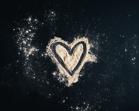 Kitchen utensils, flour in the form of a heartの写真素材