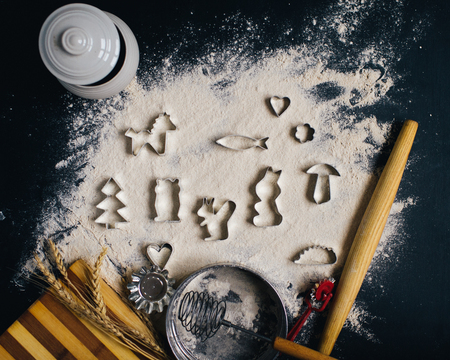 Baking or cooking background frame. Ingredients, kitchen items for baking cakes. Kitchen utensils, flour, almond, cinnamon, oil. Text space, top view.の写真素材