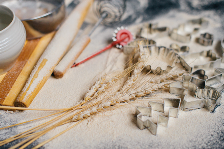 Baking or cooking background frame. Ingredients, kitchen items for baking cakes. Kitchen utensils, flour, almond, cinnamon, oil. Text space, top view.の写真素材