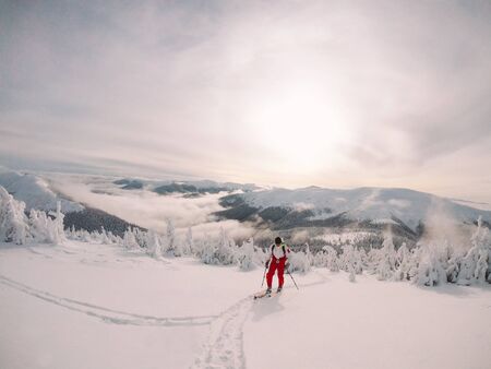 Skier, skiing. Rises to high mountains against the sunset, Ukraineの写真素材