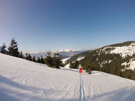 Road through deep snow. Beautiful sunny day with deep blue sky at a mountains with lot of snow all over the placeの写真素材