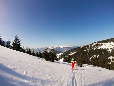 Road through deep snow. Beautiful sunny day with deep blue sky at a mountains with lot of snow all over the placeの写真素材