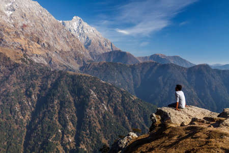 A man is looking at the mountains