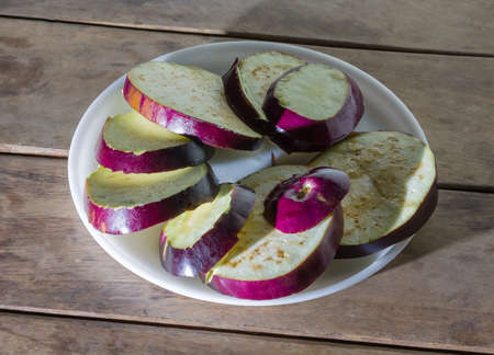 Fresh aubergines in the plateの写真素材