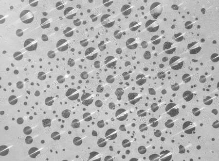 Drops of water on glass with shadowsの写真素材
