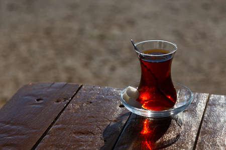 A cup of Turkish tea on a wooden table