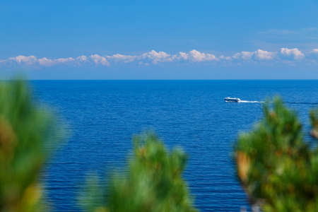 Blue lake with sky and shipの写真素材