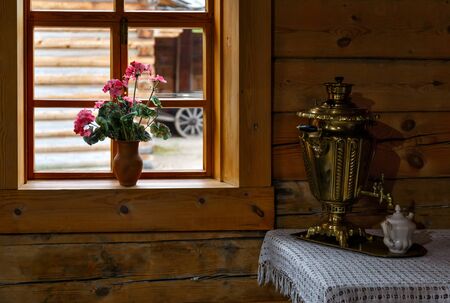 Samovar at old style Russian kitchen in wooden house with windowの写真素材