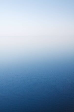 Smoked from fires white air over Baikal lakeの写真素材