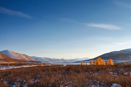 Mountain plateau in September covered with snow and blue sky in Russia