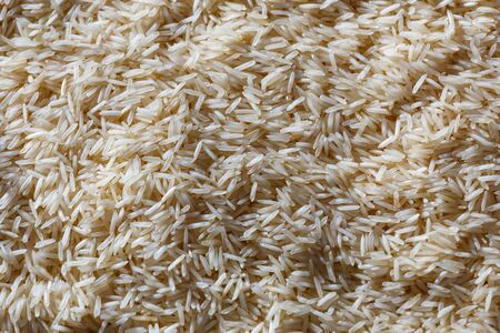 Close up of light color basmati rice background with contrast lightの写真素材