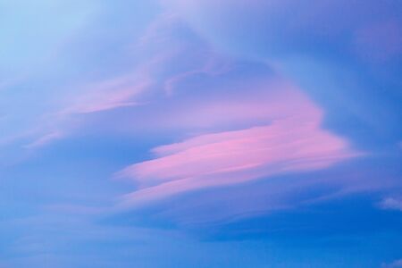 Lenticular cloud in sunset light with pink and blue colors over Baikal lakeの写真素材
