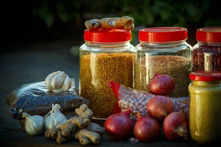 Donations food with rice, lentils, onions, ginger, peanuts on with dark background on wooden surfaceの写真素材