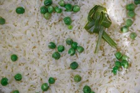 Closeup of cooked basmati rice with green peas and lemon grassの写真素材