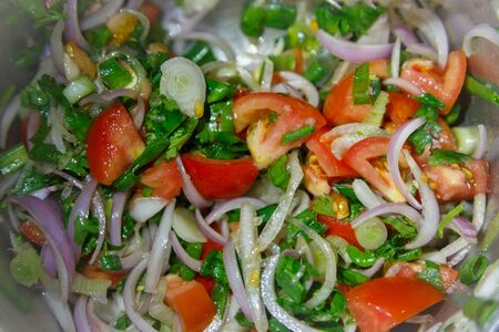 Salad with fresh tomatoes, onions, coriander leavesの写真素材
