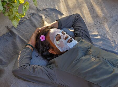 Indian bearded man relaxing with facial maskの写真素材