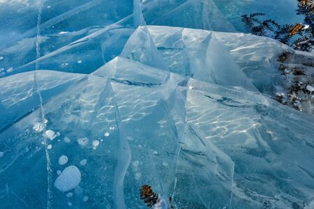 Abstract ice cracks of frozen Baikal lake of blue colorの写真素材