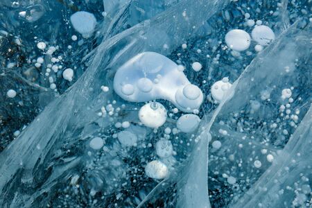 Ice cracks and frozen bubbles of gas in Baikal lakeの写真素材